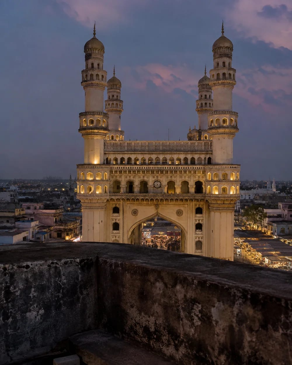 The Charminar rising above Hyderabad's old city at blue hour