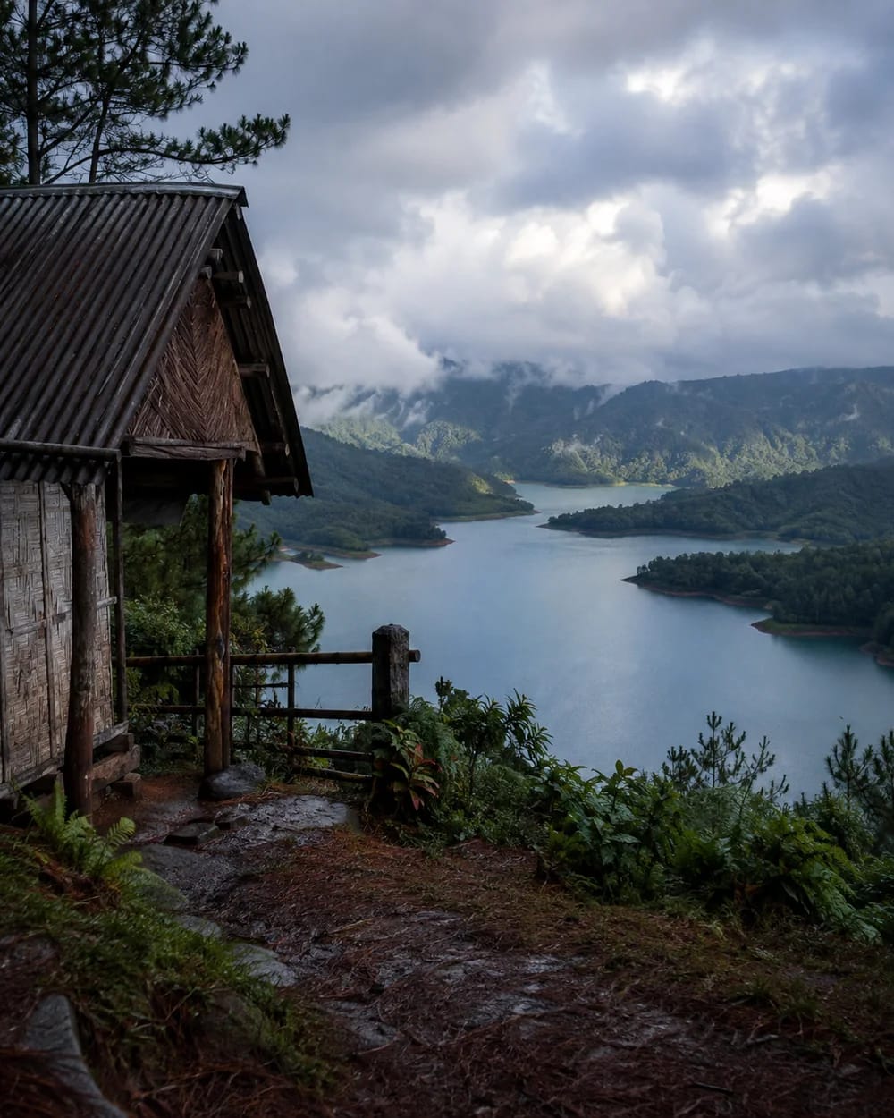 A rain-darkened hill shelter overlooking Umiam Lake near Shillong